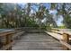 Relaxing wooden deck overlooking lush foliage and trees at 11528 28Th Street E Cir, Parrish, FL 34219