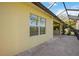 Peaceful screened patio with paver tile and window overlooking the backyard at 11634 Piedmont Park Xing, Bradenton, FL 34211