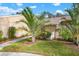 Landscaped front yard with palm trees and walkway at 1214 Tallywood Dr # 7020, Sarasota, FL 34237