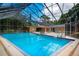 Enclosed pool area with seating and patio furniture at 1214 Tallywood Dr # 7020, Sarasota, FL 34237