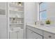 Bright bathroom with white vanity, shelving and gold accents at 1310 Rosery Ne Rd, Largo, FL 33770