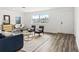 Bright living room with blue sofa and wood-look flooring at 1310 Rosery Ne Rd, Largo, FL 33770