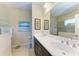Bright bathroom with dual vanities, a walk-in shower, and modern fixtures at 1387 Still River Dr, Venice, FL 34293