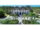 Aerial view of community clubhouse with palm trees and circular driveway at 1387 Still River Dr, Venice, FL 34293