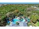 Aerial view of the community pool with a checkered pool deck and lush landscaping at 1387 Still River Dr, Venice, FL 34293