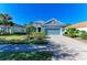 Charming blue single-story home with a two-car garage and landscaped yard at 1387 Still River Dr, Venice, FL 34293