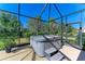 Screened-in hot tub with lush landscaping and steps for easy access at 1387 Still River Dr, Venice, FL 34293