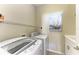 Laundry room with washer, dryer, and folding counter at 1387 Still River Dr, Venice, FL 34293