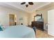 Calming main bedroom with a ceiling fan, wood flooring, and an ensuite bathroom at 1387 Still River Dr, Venice, FL 34293