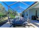 Screened patio with an outdoor dining table and a hot tub at 1387 Still River Dr, Venice, FL 34293