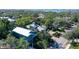 An aerial shot showcasing a teal house nestled in a tree-lined neighborhood at 1732 Hillview St, Sarasota, FL 34239