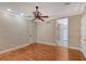 A primary bedroom featuring wood floors, base trim, and an ensuite bathroom with glass shower at 1732 Hillview St, Sarasota, FL 34239