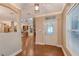 Bright and airy entryway with hardwood floors and a view into the living area at 1732 Hillview St, Sarasota, FL 34239