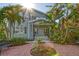 Charming two-story home with a landscaped front yard, tropical foliage, and inviting porch at 1732 Hillview St, Sarasota, FL 34239
