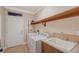 Laundry room with washer, dryer, and utility sink at 1732 Hillview St, Sarasota, FL 34239