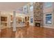 A spacious living room featuring a stone fireplace, hardwood floors, and high ceilings at 1732 Hillview St, Sarasota, FL 34239