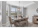 Inviting dining room with wood table, chairs, bench, and large windows offering natural light and picturesque views at 17704 Gawthrop Dr # 103, Bradenton, FL 34211