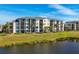 Building exterior overlooking a tranquil lake setting at 17704 Gawthrop Dr # 103, Bradenton, FL 34211