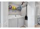 Efficient laundry room featuring a washer, dryer, storage shelf, and easy access at 17704 Gawthrop Dr # 103, Bradenton, FL 34211