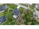 Aerial view showcases fenced yard, lush greenery, and neighboring houses, offering privacy and a sense of community at 1859 Lamont St, North Port, FL 34288
