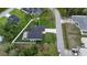 Aerial view features privacy landscaping, well-kept lawn, and a view of the community with houses and pools at 1859 Lamont St, North Port, FL 34288