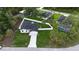 Aerial view of a home surrounded by a white fence, well-manicured lawn, mature trees and a paved driveway at 1859 Lamont St, North Port, FL 34288