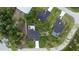 Aerial view showcasing privacy with mature trees, well-maintained landscaping and neighboring homes with pools at 1859 Lamont St, North Port, FL 34288