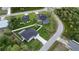 Aerial view of a home with well-maintained lawn, surrounding greenery, and nearby houses, creating a serene environment at 1859 Lamont St, North Port, FL 34288