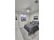 Cozy bedroom featuring a large window, gray bedding, light wood floors, and modern decor for a comfortable retreat at 1859 Lamont St, North Port, FL 34288