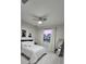 This bedroom features a ceiling fan, natural light, and neutral decor with a simple yet tasteful aesthetic at 1859 Lamont St, North Port, FL 34288