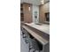 Kitchen island features quartz counters, a built-in bench, and pendant lighting, creating an inviting atmosphere at 1859 Lamont St, North Port, FL 34288