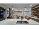 Open-concept kitchen with a large island, quartz countertops, and views into the living room and dining area at 1859 Lamont St, North Port, FL 34288