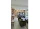 Open-concept living and kitchen area with modern cabinetry, a center island with seating, and plush, comfortable seating at 1859 Lamont St, North Port, FL 34288
