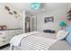 Comfortable bedroom with a gray bed, decorative lamps and artwork at 208 Ariano Ave, Nokomis, FL 34275