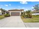 Single-story home with brown garage door, landscaping, and a paved driveway at 208 Ariano Ave, Nokomis, FL 34275