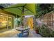 Charming patio with table, chairs, umbrella, and lush greenery at 2674 Jefferson Cir, Sarasota, FL 34239