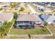 Aerial view of a home with a screened-in pool and a white picket fence at 301 Gold Tree, Punta Gorda, FL 33955