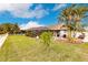 Large backyard with lush lawn and screened pool enclosure at 301 Gold Tree, Punta Gorda, FL 33955