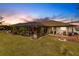 Enjoy sunsets from this backyard with a screened pool and fire pit at 301 Gold Tree, Punta Gorda, FL 33955