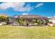 Expansive backyard featuring a screened pool and lush landscaping at 301 Gold Tree, Punta Gorda, FL 33955