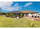 Large backyard with screened pool, lush landscaping, and fire pit at 301 Gold Tree, Punta Gorda, FL 33955