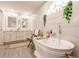 Spa-like bathroom with a freestanding tub, double vanity, and marble tile at 301 Gold Tree, Punta Gorda, FL 33955