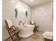 Relaxing bathroom with a freestanding tub, double vanity, and marble tile at 301 Gold Tree, Punta Gorda, FL 33955