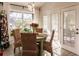 Bright dining area with a round table, four chairs, and access to the backyard at 301 Gold Tree, Punta Gorda, FL 33955