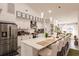 Modern kitchen with white cabinets, quartz countertops, and island seating at 301 Gold Tree, Punta Gorda, FL 33955