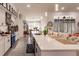 Large kitchen island with seating, white cabinetry, and stainless steel appliances at 301 Gold Tree, Punta Gorda, FL 33955