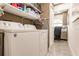 Convenient laundry room with washer, dryer, and shelving at 301 Gold Tree, Punta Gorda, FL 33955