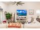 Relaxing living room with sectional sofa, fireplace, and large TV at 301 Gold Tree, Punta Gorda, FL 33955