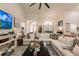 Open living room with large sectional sofa, coffee table, and big screen TV at 301 Gold Tree, Punta Gorda, FL 33955