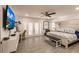 Spacious main bedroom with king-size bed, built-in desk, and French doors leading to patio at 301 Gold Tree, Punta Gorda, FL 33955